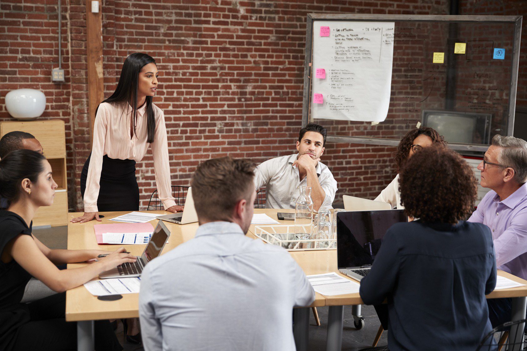 A new female HR leader standing at a desk with the hierarchy